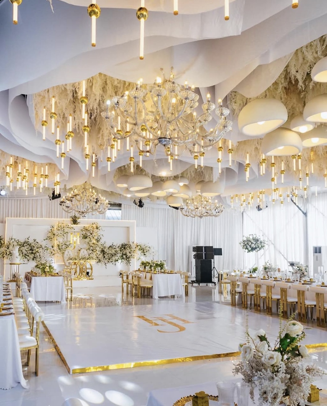 Reception hall with a sculpted white and gold ceiling installation